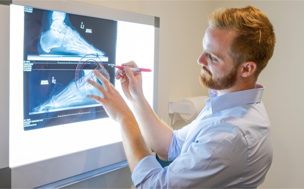 Podiatrist looking at xray machine with CPD techniques