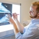 Podiatrist looking at xray machine with CPD techniques